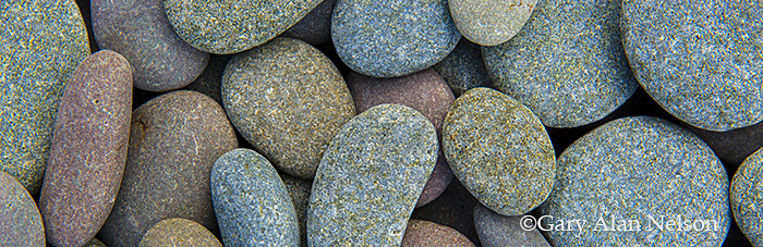 Surf rounded stones on the shore of Lake Superior, Split Rock Lighthouse State Park, Minnesota