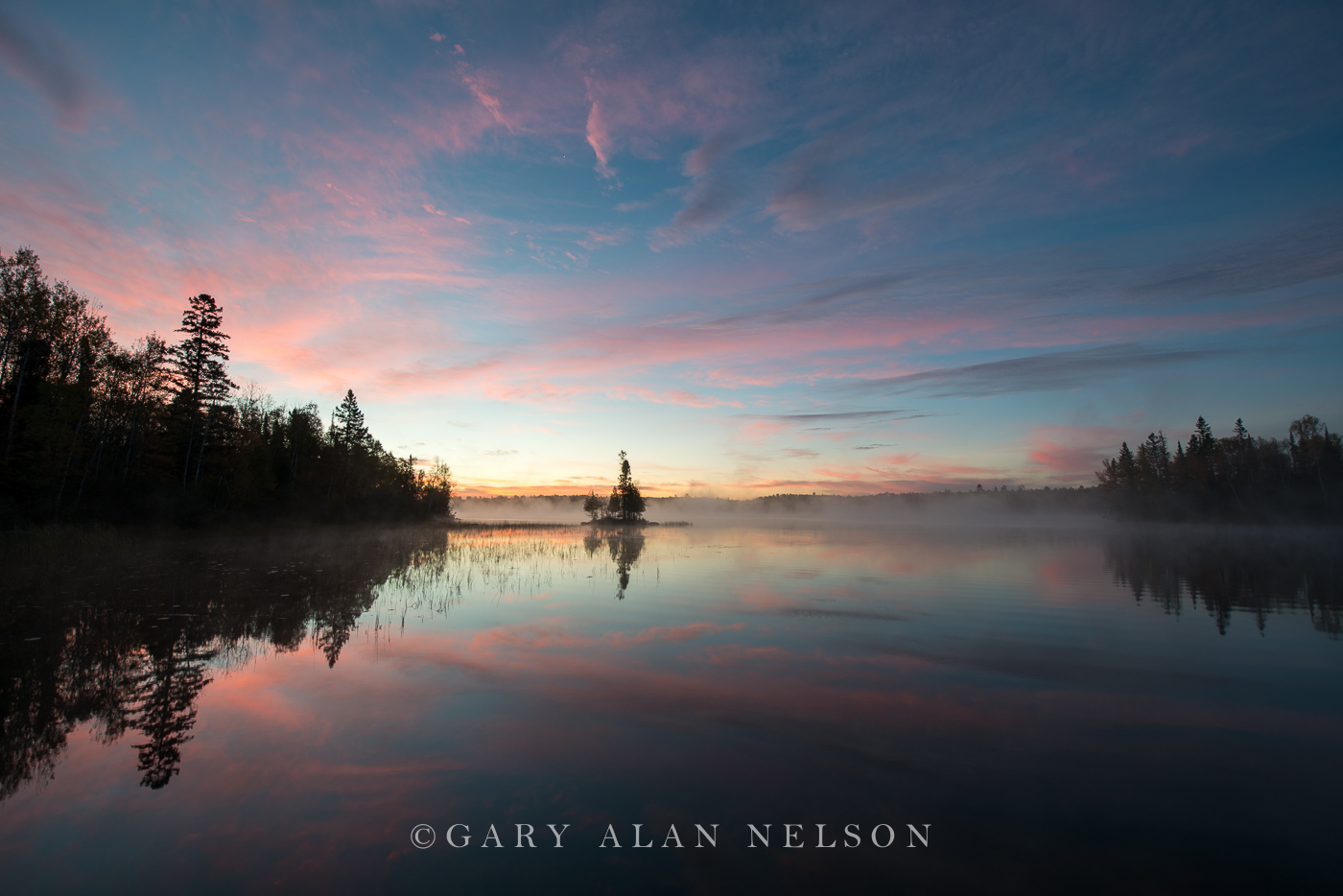Island and the blush of dawn over lake, Superior National Forest, Minnesota