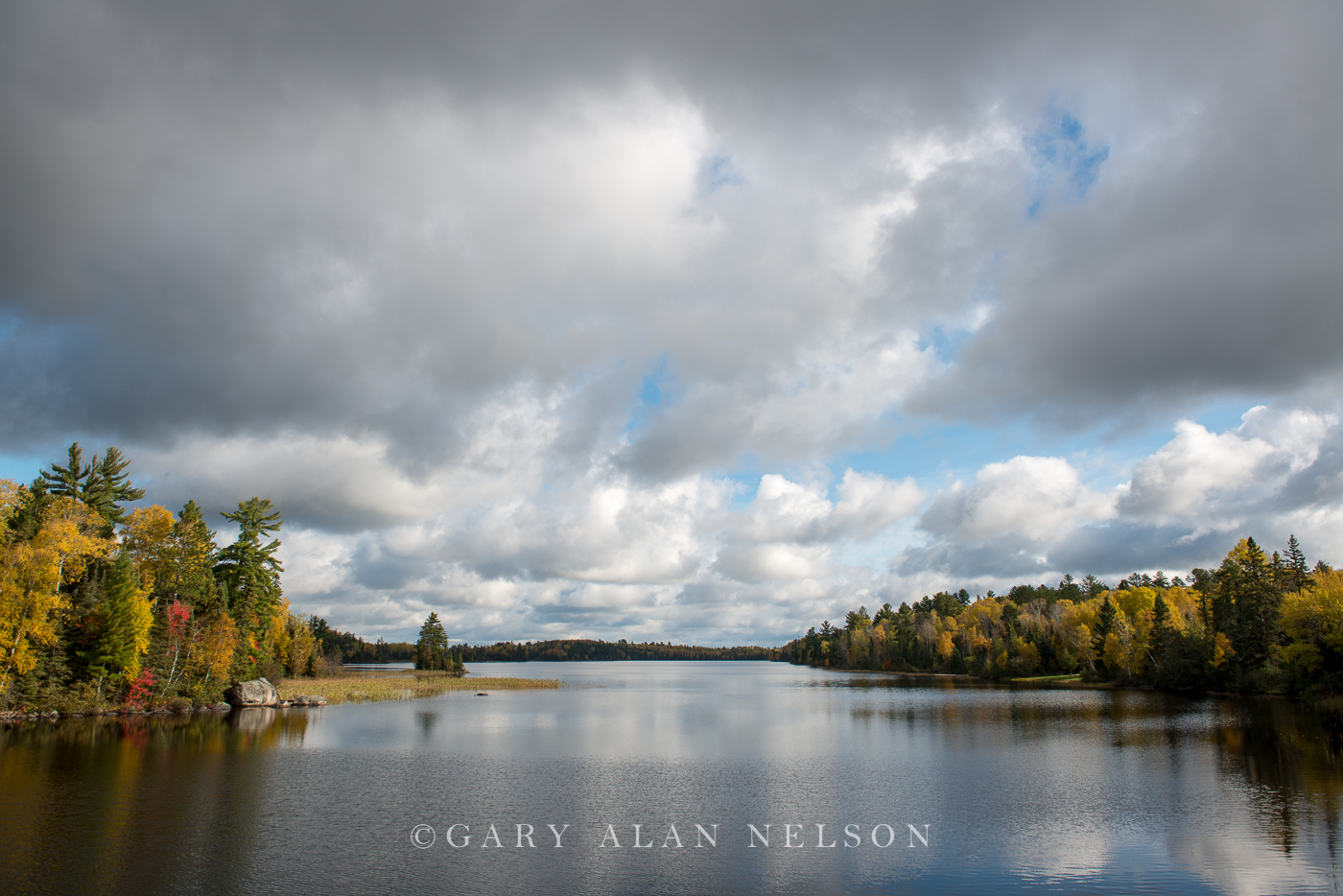 Autumn colors and clouds over the Kawishiwi River, Superior National Forest, Minnesota.