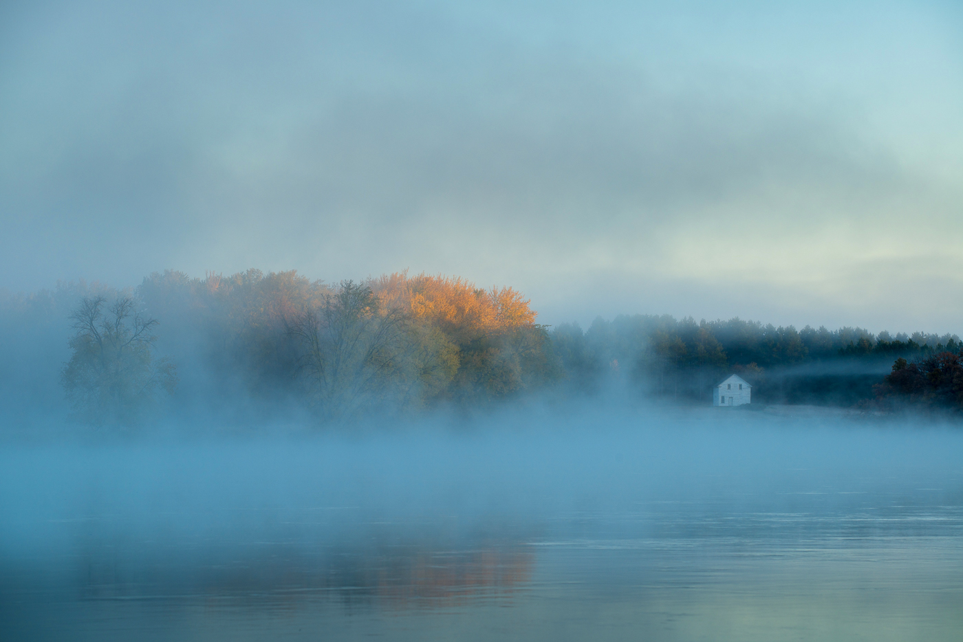 Fog over the Mississippi River and the historic Beaulieu House in the Old Crow WIng Townsite, Crow Wing State Park, Minnesota...