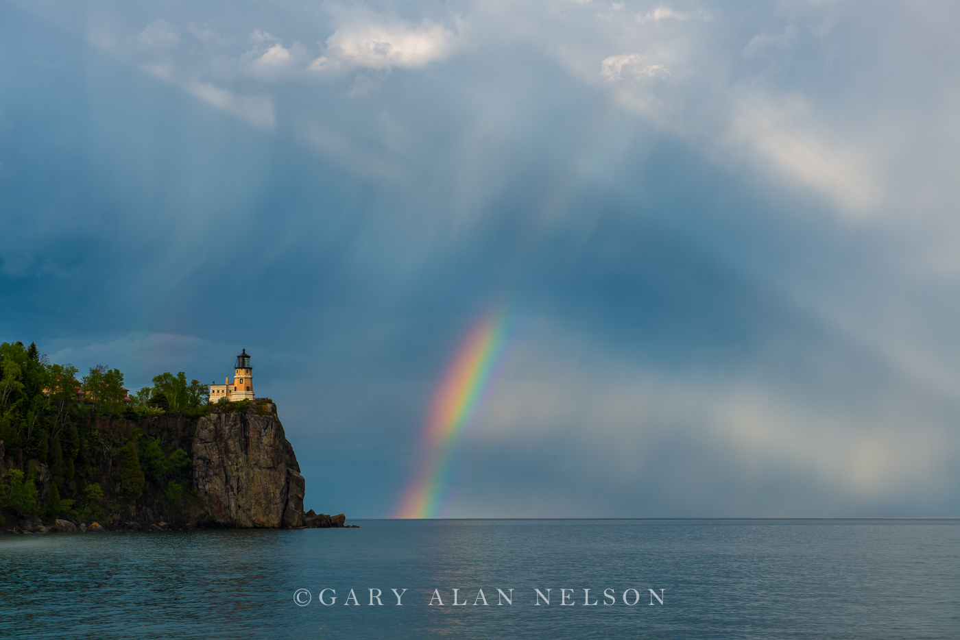 Rainbow and sun rays over Lake Superior and Split Rock Lighthouse, Minnesota